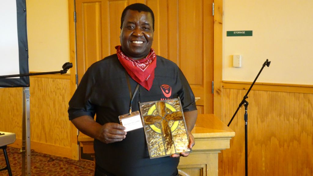 Rev. Maulana with stained glass cross done by Rick Teague